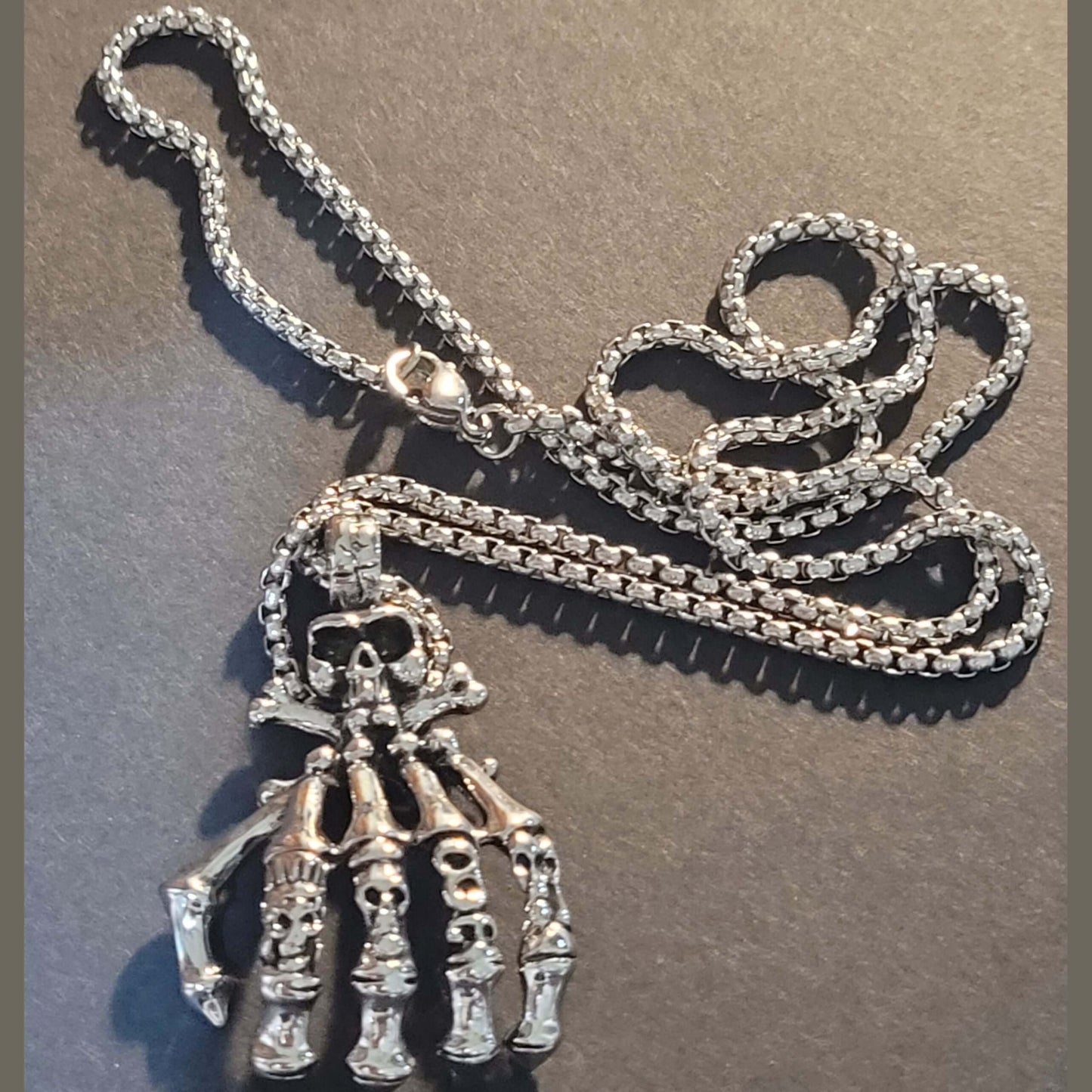 Dark Embrace: Skull Hand Punk Necklace for Men & Women