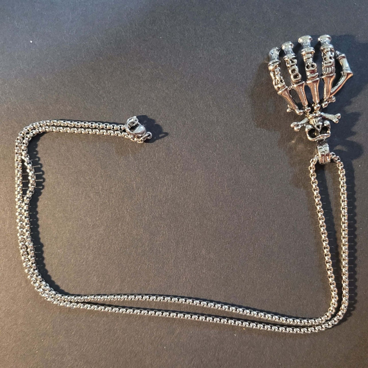 Dark Embrace: Skull Hand Punk Necklace for Men & Women